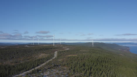 Beautiful-Landscape-By-The-Windmills-Of-Osen,-Norway-Under-A-Bright-Sunny-Day---Aerial-Distant-Shot