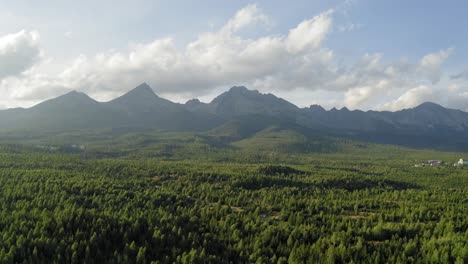 Wonderful-Nature-In-Slovakia-During-Golden-Hour-Over-High-Tatry-Forest-With-Cloudy-Blue-Sky-In-the-Background---Aerial-shot
