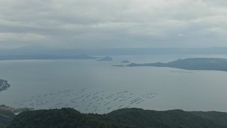 Zoom-in-shot-of-the-enchanting-view-from-misty-Taal-Lake-and-the-Island-of-Taal-Volcano