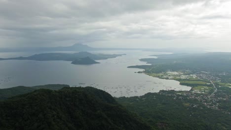 Scenic-eye-capturing-view-of-Taal-Volcano-surrounded-by-the-tranquil-misty-Taal-lake-under-cloudy-sky