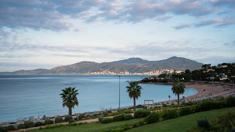 Time-lapse-of-the-clouds-passing-in-the-morning-over-the-mountains-and-the-city-of-Ajaccio-in-Corsica,-France,-in-the-summer