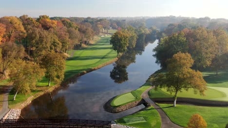 Autumn-trees-reflected-in-the-Conestoga-River-at-Lancaster-Country-Club,-beautiful-fall-golf-course-view