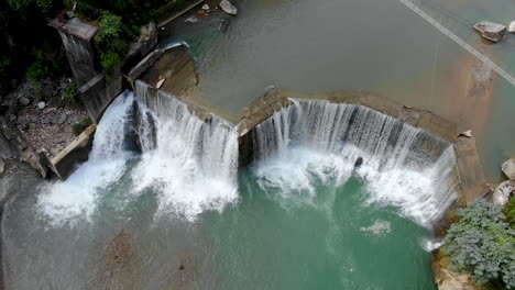 Aerial-large-river-turning-into-a-huge-waterfall-in-the-mountains