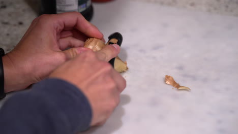 Cutting-and-peeling-a-fresh-piece-of-ginger-root