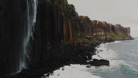 Stunning-Waterfall-on-Sea-Cliffs-on-Scottish-Isle-of-Skye-Island,-Aerial