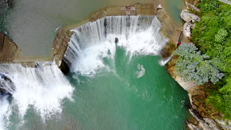Bird's-eye-view-large-river-turning-into-a-huge-waterfall-in-the-mountains
