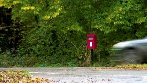 A-red-letter-box-on-the-side-of-a-road-in-rural-Rutland-in-England