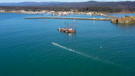Sunny,-aerial-dolly-toward-Pacific-dredging-boat-in-Northern-California
