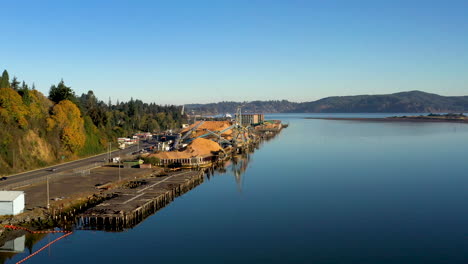 Sunny,-smooth-aerial-dolly-over-Coos-Bay-and-mill-in-Pacific-Northwest