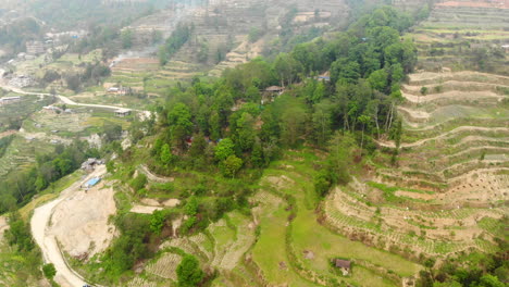 Aerial-footage-of-step-farming-or-terrace-farming-and-dirt-road-in-a-remote-area-in-the-mountains