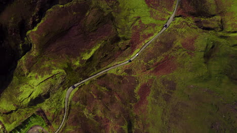 Isle-of-Skye,-Scotland-UK,-Cinematic-Top-Down-Aerial-View-of-Curvy-Road-Bewteen-Hills-in-Autumn-Foliage-Colors