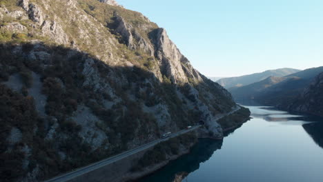 Scenic-road-beside-River-Neretva-in-Bosnia-mountainous-countryside,-aerial
