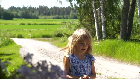 Girl-who-caught-a-butterfly-on-a-gravel-road-during-summertime