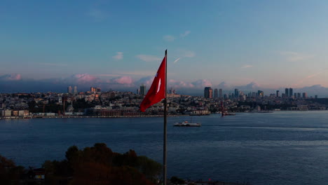 Aerial-point-of-view-shot-of-the-Turkish-flag-flying-over-Istanbul-at-dawn