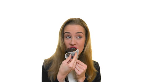 Slim-business-woman-eats-chocolate-cupcake-with-taste