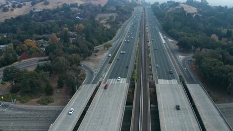 Pan-down-over-traffic-in-the-smokey-hills-of-California