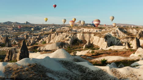 Morning-flight-for-a-flotilla-of-hot-air-balloons-at-Goreme-Cappadocia,-Turkey