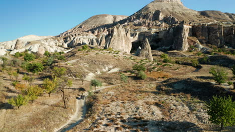 A-young-woman-rides-a-quad-bike-through-the-landscapes-of-Cappadocia,-Turkey