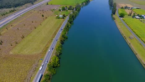 A-Motorway-Highway-Built-By-The-Clarence-River,-Australia-On-A-Bright-Sunny-Day---Aerial-Shot