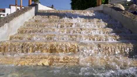 Static-shot-of-a-stone-stairs-fountain,-at-a-hotel,-on-a-sunny-day,-in-California,-USA