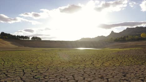 Time-lapse-of-a-dried-out-lake-and-a-dam-during-summer-drought