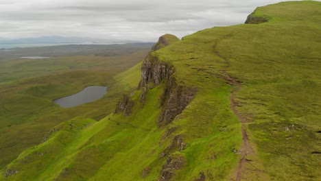 Aerial-shot-of-a-lush-green-ridge-in-Scotland-during-an-overcast-day