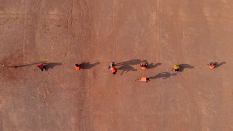 drone-shot-of-school-kids-playing-Indian-sports-Kho-Kho-in-sed-sand-of-Maharashtra