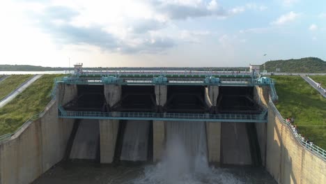 Aerial-Cinematic-view,-Zoom-out-shot-of-Water-reservoir---Establishing-shot-of-Dam---Water-releasing-from-the-reservoir-gates-during-hot-sunny-day