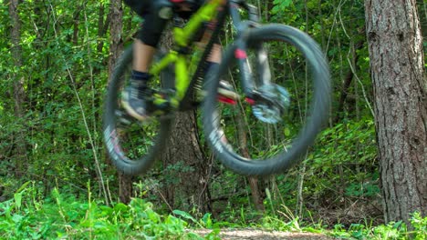 An-enthusiast-cyclist-riding-and-jumping-through-the-bump,-on-his-mountain-bike