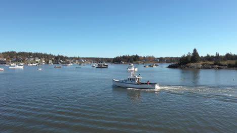 Aerial-Fly-by-Follow-Drone-footage-of-Lobster-Boat-at-Maine-Coast,-Vinalhaven,-Fox-Islands,-Knox-County,-Maine,-USA