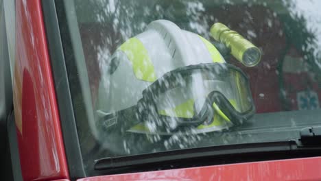 White-firefighter-helmet-in-windshield-of-vehicle,-Close-Up-Detail