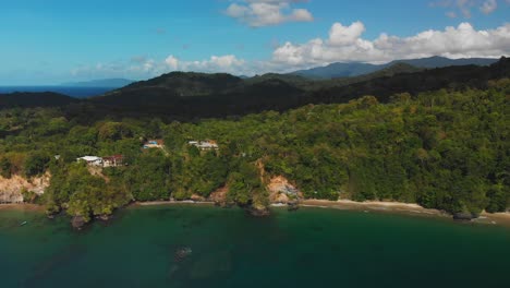Epic-aerial-of-secluded-beaches-only-accesible-by-boat-with-mountains-and-a-cloudscape-in-the-background-on-the-Caribbean-island-of-Trinidad-and-Tobago