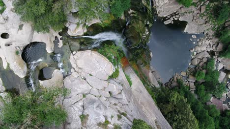 Majestic-Waterfall-from-Steep-Cliff-at-Salt,-Girona,-Catalonia,-Aerial-Rising-and-Circling