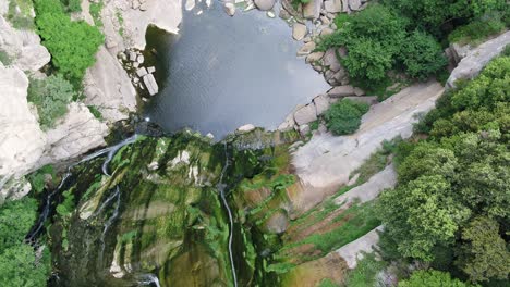 Powerful-Aerial-Reveal-of-Lake-and-Steep-Waterfall-at-Salt,-Girona,-Catalonia