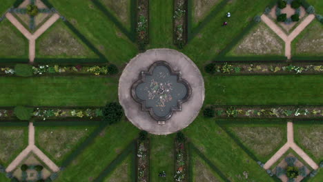 Aerial-shot-of-absolute-symmetry-of-a-French-park-with-a-fountain
