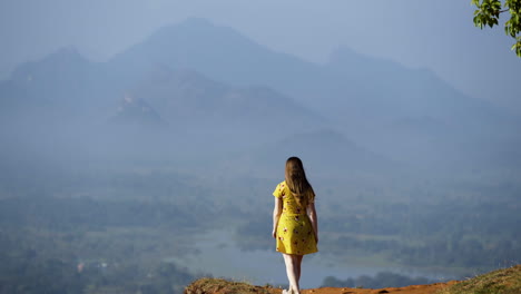 Young-female-tourist-explores-Lions-Rock-and-the-Dramatic-Sri-Lankan-Landscapes