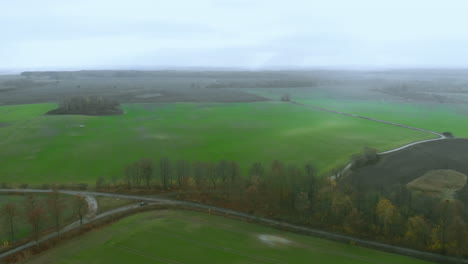 Panoramic-footage-over-green-field-and-village-horizon