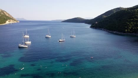 Beautiful-tranquil-sea-inlet-in-Greece-with-sail-boats,-aerial