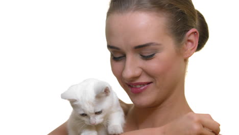 Beautiful-cheerful-woman-with-healthy-skin-with-a-white-young-kitty-on-her-hands