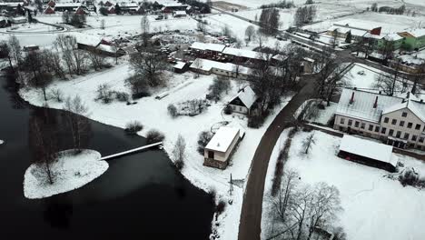 Slow-drone-shot-over-lake-next-to-small-village