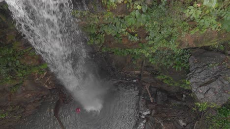Aerial-footage-of-a-cascading-waterfall-over-a-rock-formation