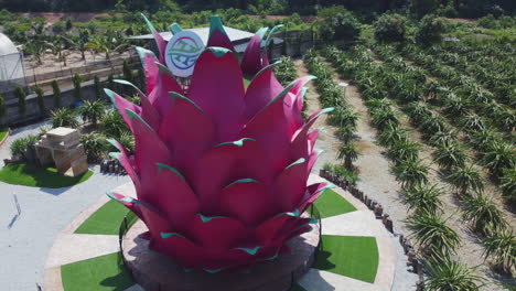 Drone-View-of-a-dragon-fruit-statue-in-a-dragon-fruit-orchard-in-Bagan-Lalang