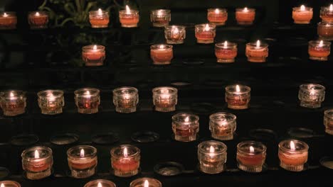 Rows-of-red-prayer-candles-in-a-church