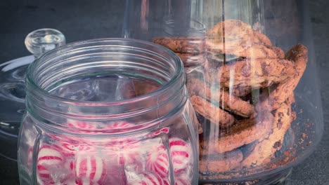 Hands-grab-candy-and-biscuits-from-glass-jars