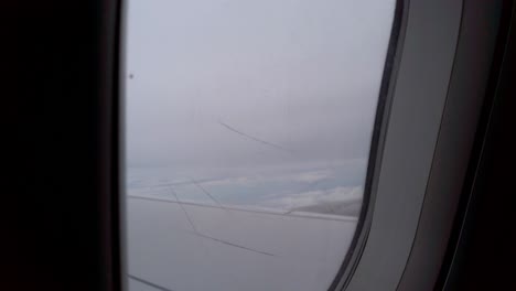 view-to-the-surface-of-the-window-with-scratch-on-surface-while-flying-on-the-sky-in-daytime