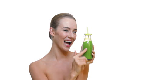 Fit-vegan-woman-drinking-green-vegetable-juice-from-glass-bottle-with-organic-straw