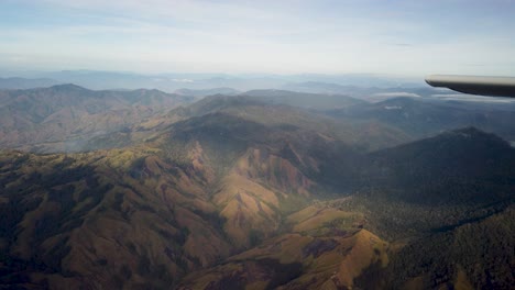 Flying-over-scenic-New-Guinea-mountains-in-small-airplane,-adventure-travel