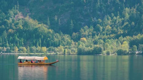 A-boat-with-visitors-pass-though-the-Hallstatter-See-in-Austria