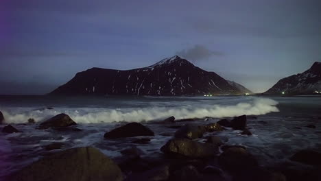 Ocean-Water-Waves-Rolling-Into-The-Rocky-Shore-During-The-Night-At-Unstad-Beach,-Lofoten-Islands,-Nordland,-Norway