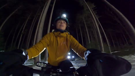 fatbike-pretty-female-rider-pov-night-winter-group-ride-exit-trail-and-smile